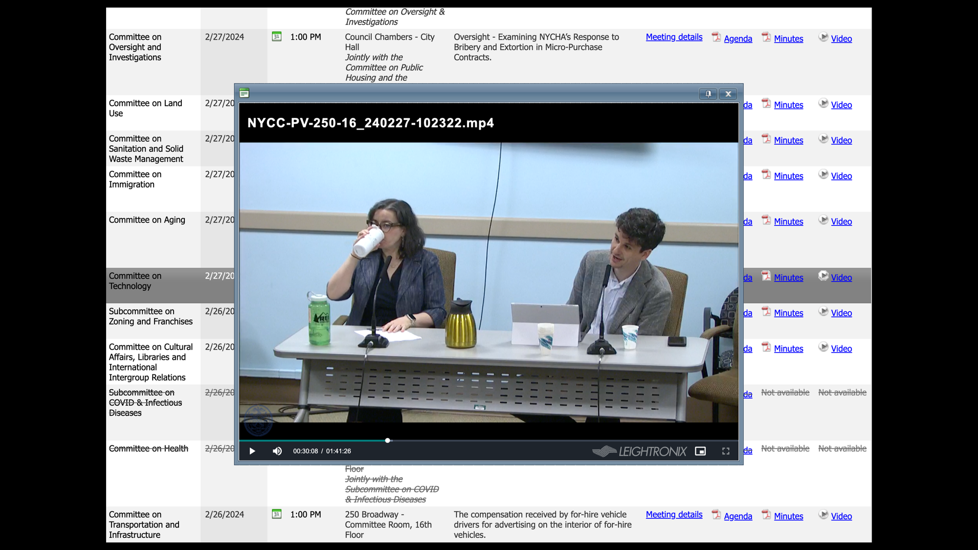 A screenshot of a video of a Committee on Technology meeting on Open Data Compliance in the NYC City Council. The video is playing on nyc.legistar.com, and in the still you can see Martha Norrick, Chief Analytics Officer of NYC and Zachary Feder, Manager of NYCs Open Data Program.